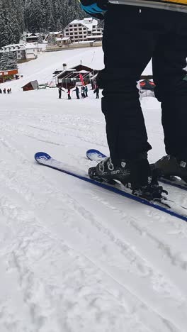 Vertical-Video-Low-angle-POV-Shot-Of-Skier-Skiing-Down-Snow-Covered-Slope